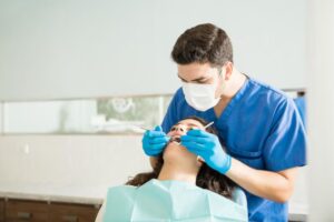 a lady is getting dental treatment