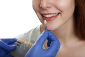dentist checking suitable dental bridge to a lady