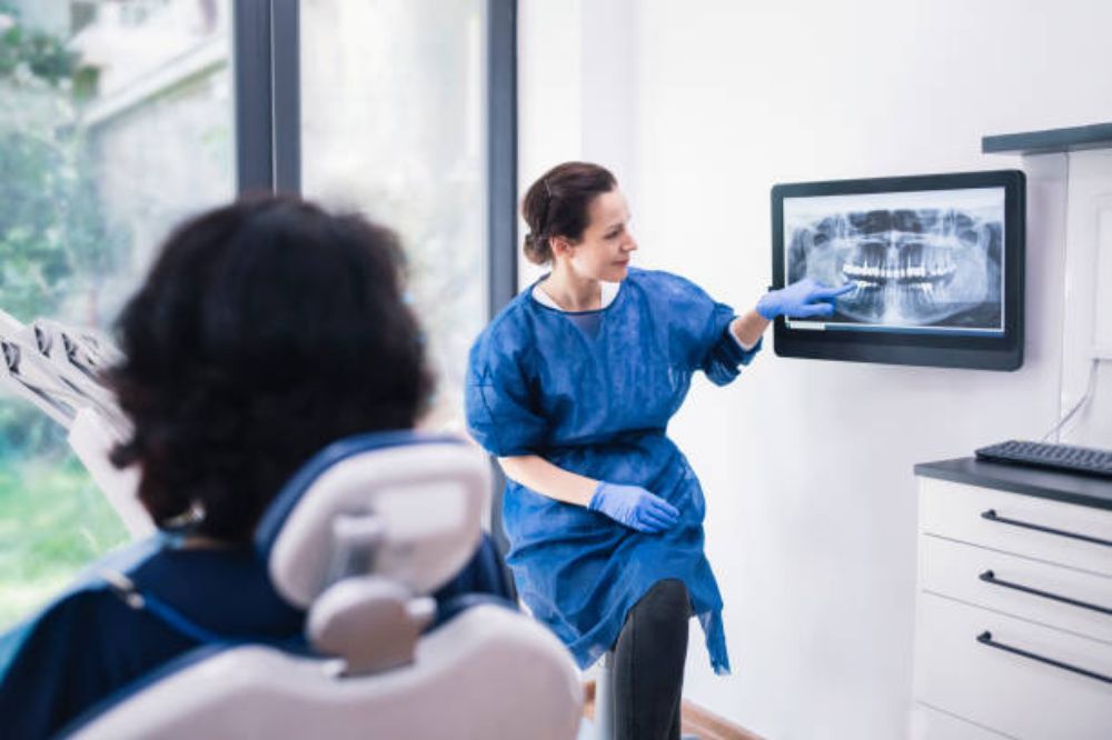 dentist showing dental report through dental technology
