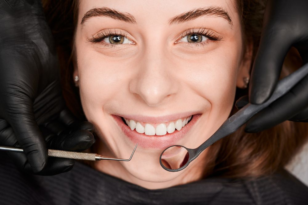 cheerful young woman having dental examination clinic